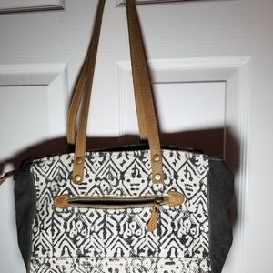 Myra bag, genuine cow hide, leather, and canvas material.